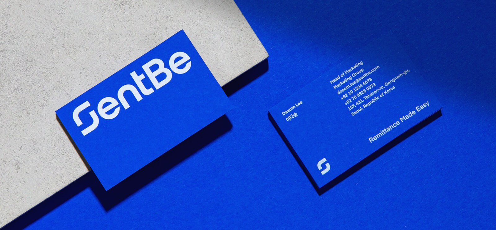 Ad Shoot-GentBe logo ,and address in a blue and gray theme and design